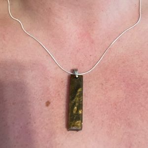 Silver chain with tiger eye style charm.